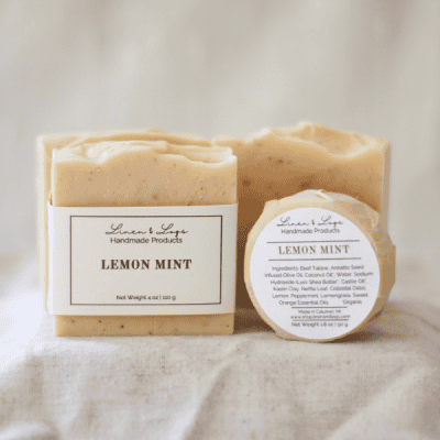 A large bar of Lemon Mint Soap next to a mini round lemon mint soap