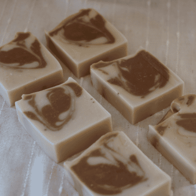 6 bars of Cedarwood Lard Soap laying on the side to show the cocoa and white swirl