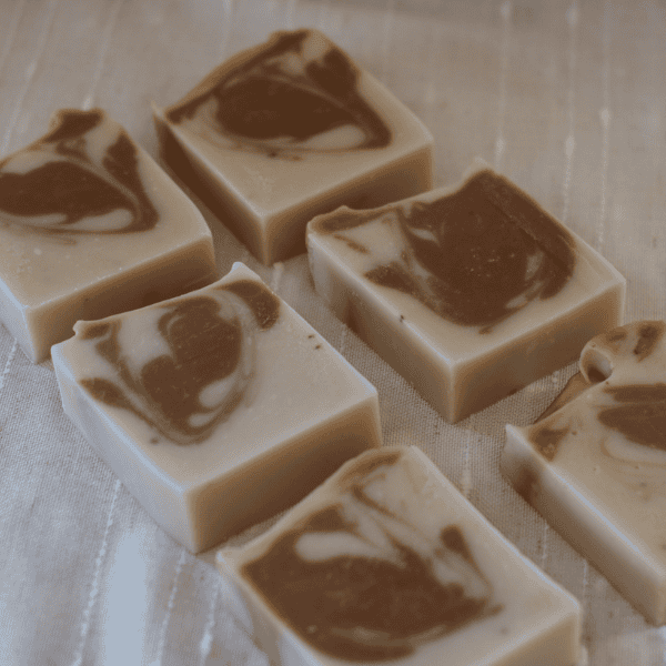 6 bars of Cedarwood Lard Soap laying on the side to show the cocoa and white swirl