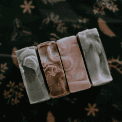 4 soap tops on a dark background from our holiday soap collection