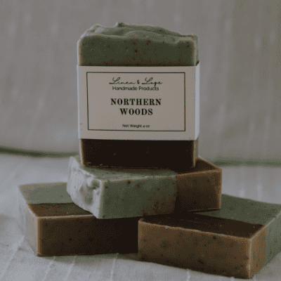 stack of Northern Woods Tallow Soap Bars - cocoa colored on bottom half and green speckled on top half