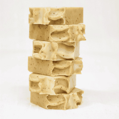 vertical stack of orange poppyseed tallow soap bars