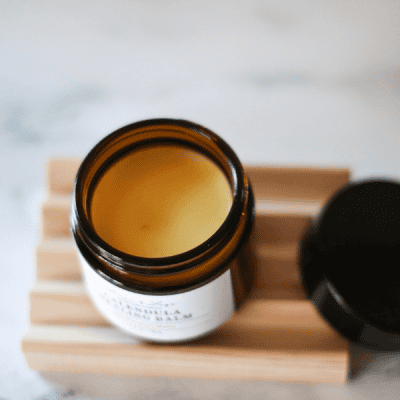 open jar of calendula healing balm showing the top of the yellow balm