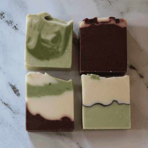 four holiday soaps laying down - eucalyptus mint, gingerbread man, peppermint candy, winter pine