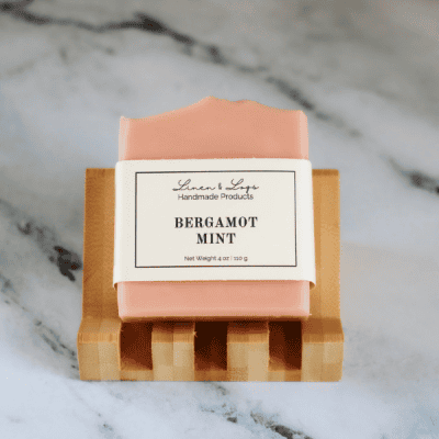 bar of bergamot mint tallow soap on a slanting soap dish