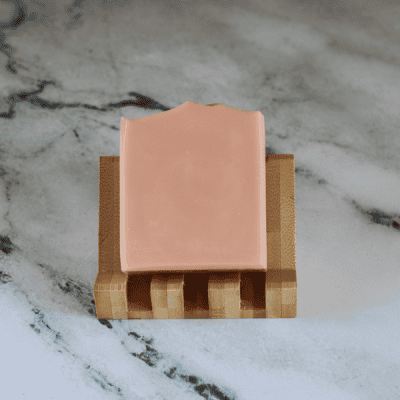 pink bar of soap on a slanting soap dish