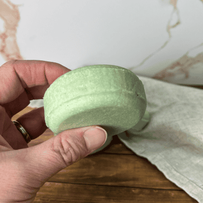 hand holding a bar of shampoo