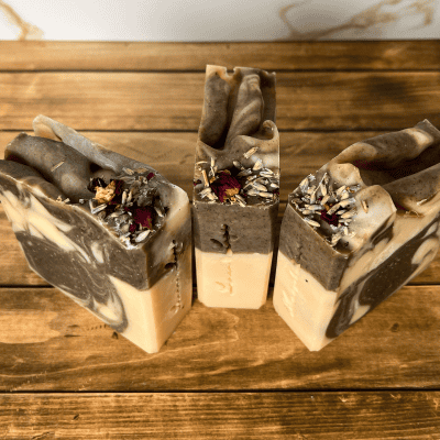 tops of Wild Flower Tallow Soap - showing the pink and purple swirls and the dried botanicals on top.