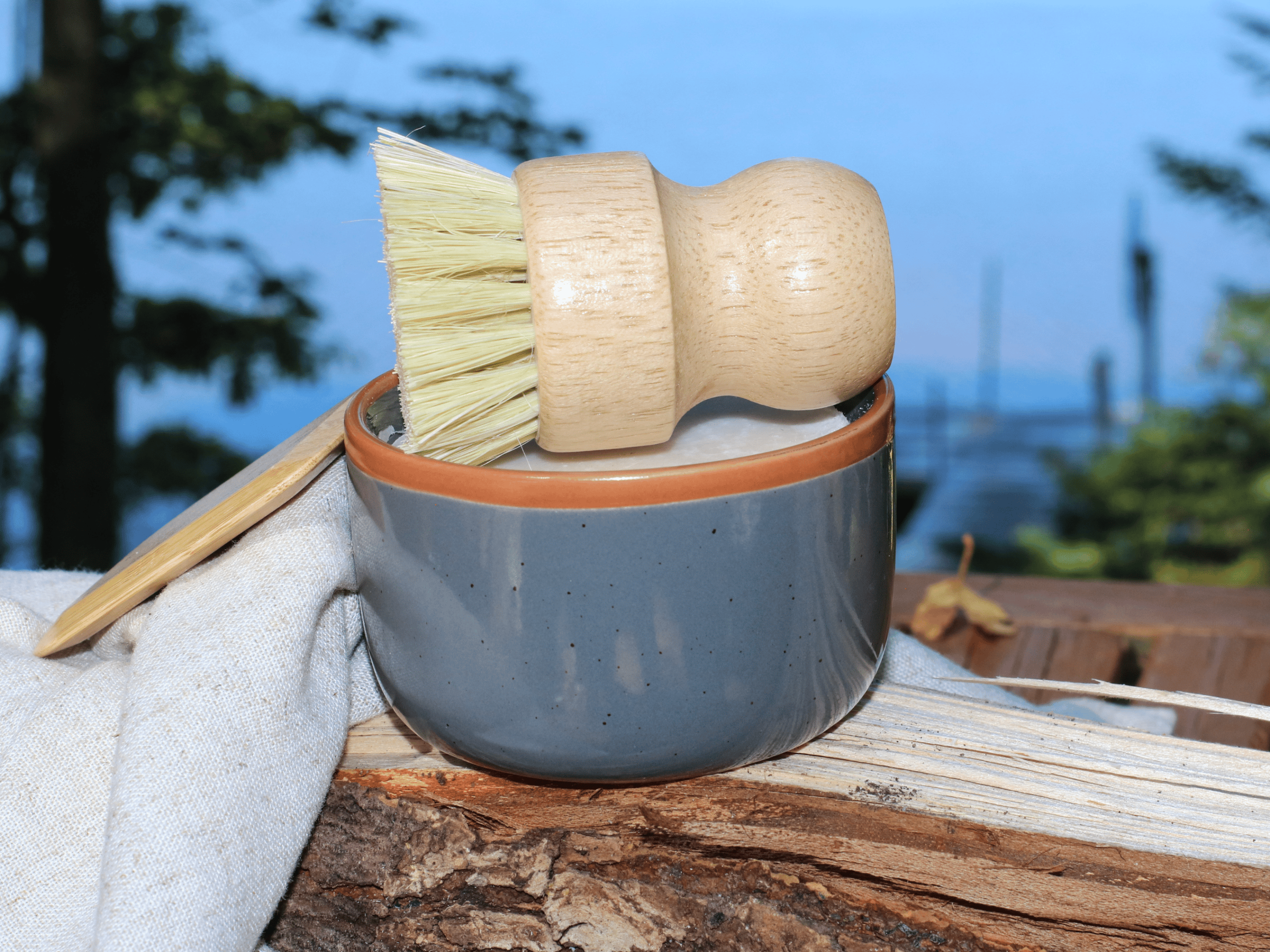 Dark gray ramekin for dish soap bar. with dish brush and bamboo scraper.