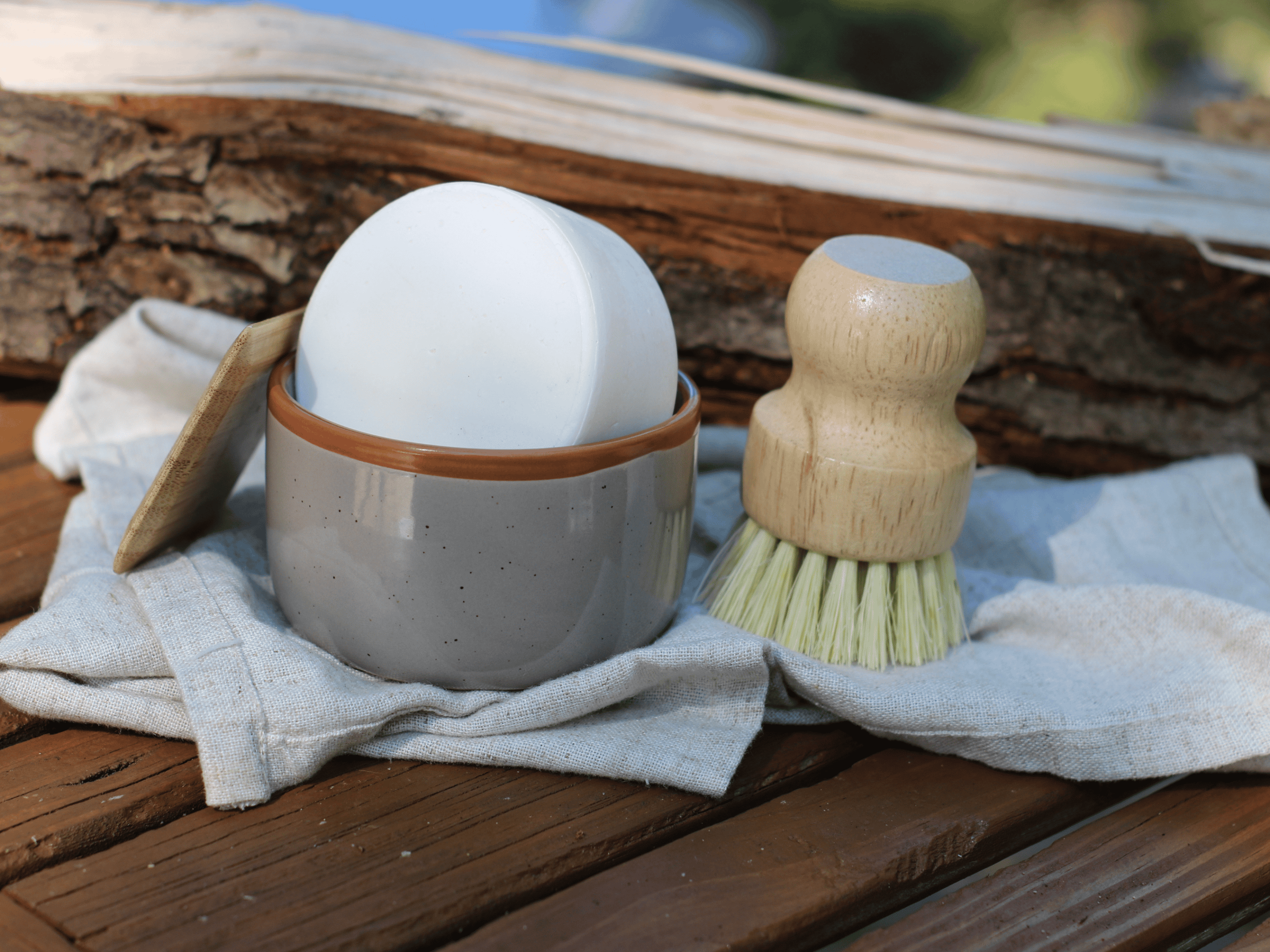 Light gray ramekin for dish soap bar. with dish brush and bamboo scraper.