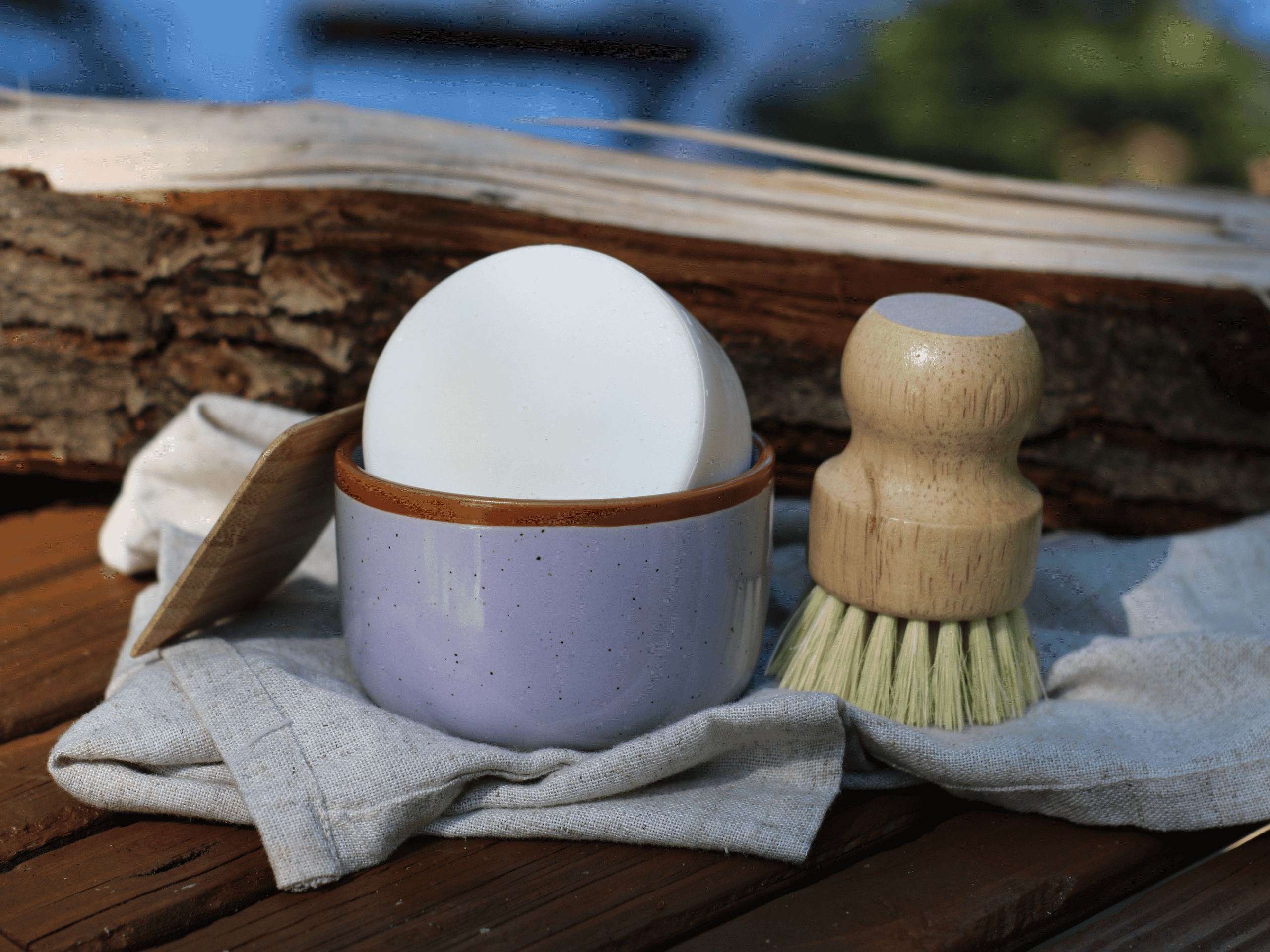 Purple ramekin for dish soap bar. with dish brush and bamboo scraper.